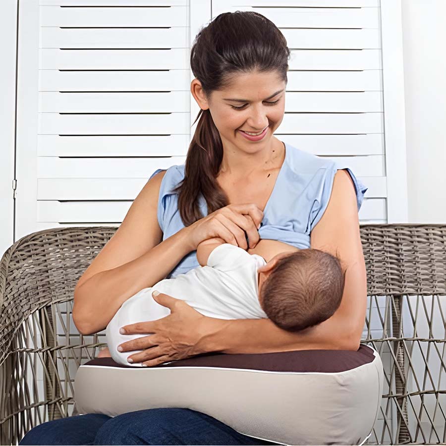 mum feeding baby supported by milkbar breastfeeding pillow