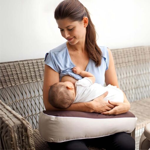 Mum feeding with Milkbar portable nursing pillow in cradle hold