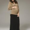 Pregnant model wearing Ripe Maternity Batwing Knit Maternity Top with black maxi skirt