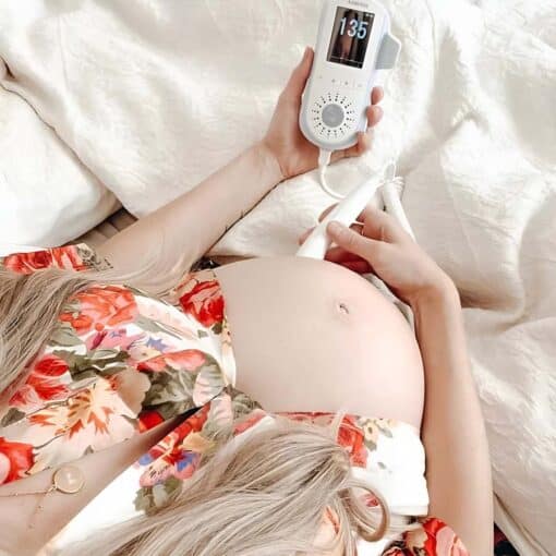 mum using premium fetal doppler with floral shirt on