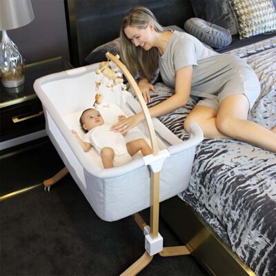 mum with baby using the kaylula cosleeper cradle next to the bed