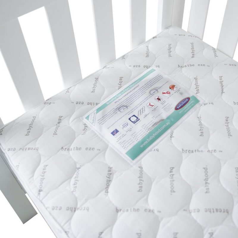 a close up of the top section of the breathe eze cot mattress and label