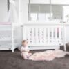Armani Sleigh cot with baby on floor
