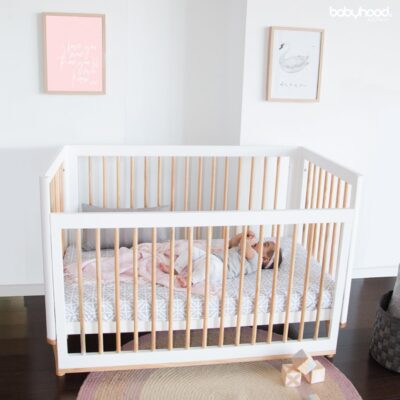 riya cot in white and natural with baby
