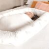organic breathe eze cosy crib with baby wrapped in white blanket