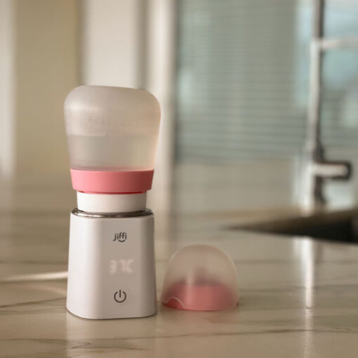 jiffi bottle warmer home with pink toddler bottle attached