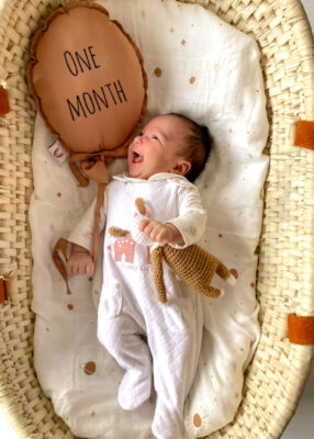 one month old alert and contented baby